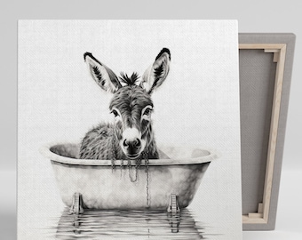 May include: Monochrome canvas print featuring a donkey relaxing in a bathtub. The donkey gazes directly at the viewer. The tub is vintage with claw feet. The canvas is stretched over a wooden frame.