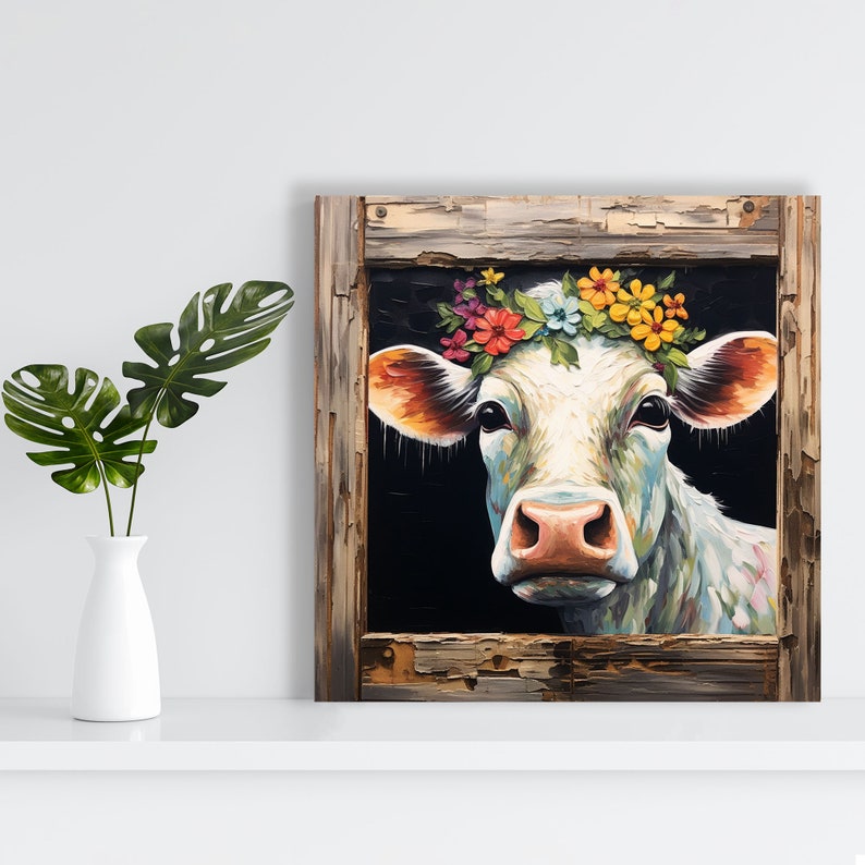 May include: A white cow with a colorful flower crown peeks through a rustic wooden frame. The cow's eyes are visible, and its pink nose is prominent. The background is dark, creating a dramatic contrast.