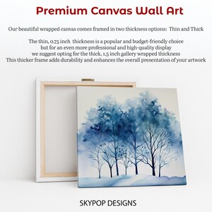 May include: Premium canvas wall art featuring a watercolor painting of blue trees. The canvas is framed in a white wooden frame, with the text "SKYPOP DESIGNS" at the bottom. The image shows the canvas in two thicknesses: 0.75 inch and 1.5 inch.