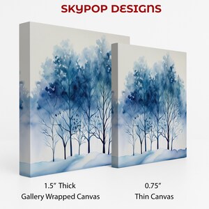 May include: Two canvas art prints featuring a watercolor painting of blue trees. The larger canvas is 1.5 inches thick, gallery wrapped, and the smaller is 0.75 inches thick, a thin canvas. The text "SKYPOP DESIGNS" is at the top.