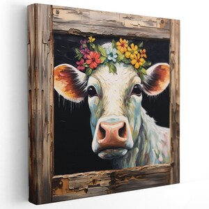 May include: A white cow with a colorful flower crown, painted in a realistic style, framed in a rustic wooden frame.