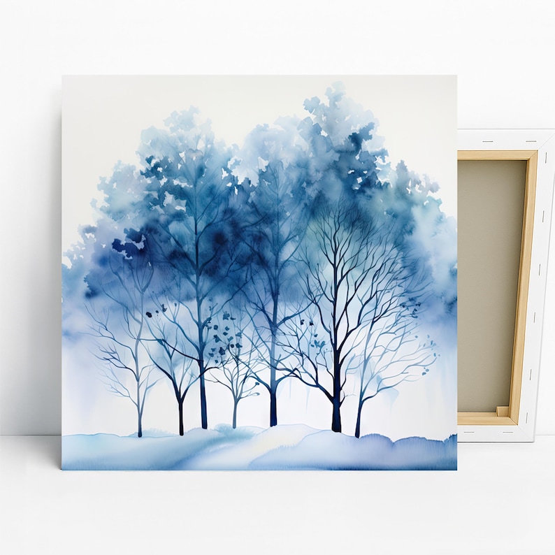 May include: A canvas print featuring a watercolor painting of a winter forest scene. The artwork showcases a cluster of trees in varying shades of blue, with delicate branches and a soft, blurred background. The overall effect is serene and evokes a sense of calm.