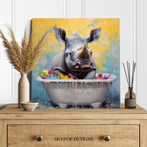 May include: A painting of a rhinoceros taking a bath in a white bathtub. The rhino is gray and has a large horn. The bathtub is filled with colorful water and bubbles. The background is a yellow and blue abstract design.