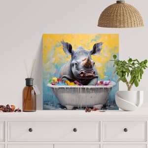 May include: A white rhinoceros taking a bath in a white bathtub filled with colorful bath toys. The rhinoceros is looking at the viewer with a serious expression. The background is a yellow and blue abstract painting.