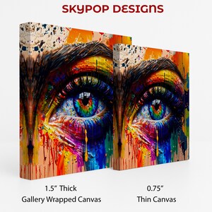 May include: Two canvas prints of a colorful eye with rainbow hues in the iris and dripping paint effects. The text "SKYPOP DESIGNS" is at the top. One canvas is 1.5" thick, gallery wrapped, and the other is 0.75" thin canvas.