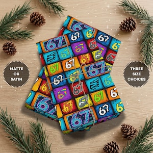 May include: Wrapping paper featuring a repeating grid pattern of the number 67 in various colourful, stylized fonts and vibrant backgrounds, tied with a thin brown string. The design includes diverse artistic treatments of the digits 67.
