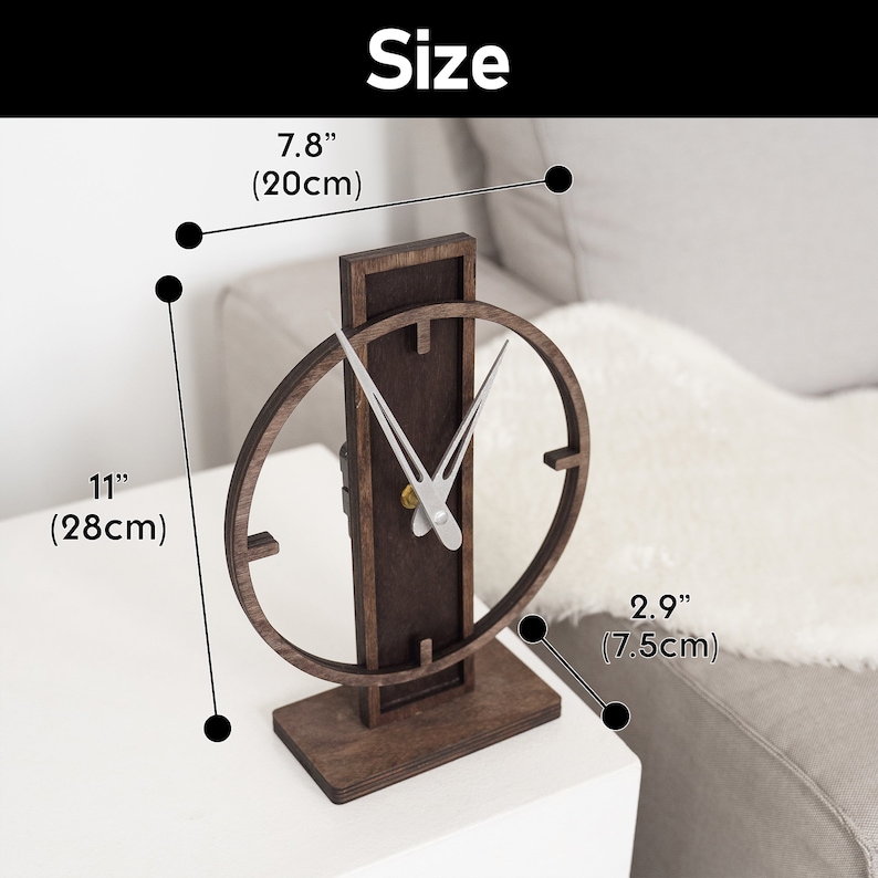 May include: A wooden desk clock with a dark brown finish. The clock has a rectangular base and a vertical support with an oval clock face. The clock is 11 inches (28cm) tall, 7.8 inches (20cm) wide, and 2.9 inches (7.5cm) deep. The word "Size" is at the top.