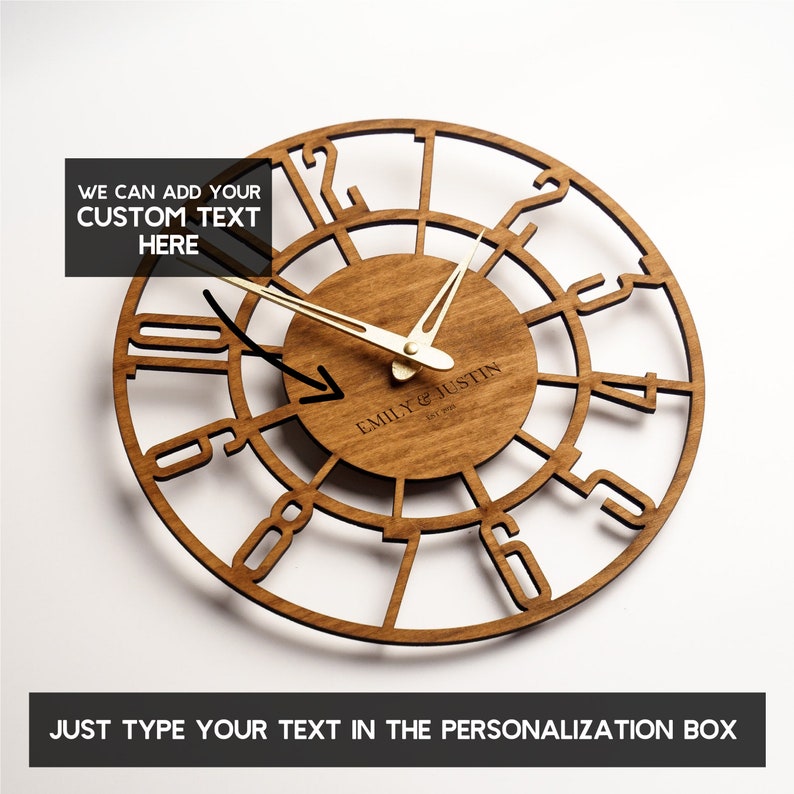 May include: A wooden wall clock with a circular design. The clock features Roman numerals and gold-colored hands. The center of the clock has the text "EMILY & JUSTIN EST 2016". The image also includes the text "WE CAN ADD YOUR CUSTOM TEXT HERE" and "JUST TYPE YOUR TEXT IN THE PERSONALIZATION BOX".