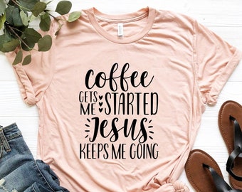 May include: A pink t-shirt with the text "coffee gets me started jesus keeps me going" in black lettering.