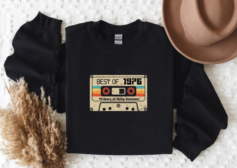 May include: Black sweatshirt featuring a vintage cassette tape graphic that reads "Best of 1976" and "40 Years of Being Awesome".