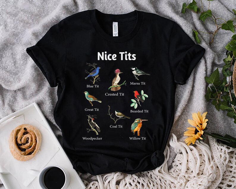May include: Black t-shirt with a humorous design featuring different types of birds with the text "Nice Tits" and the names of each bird.