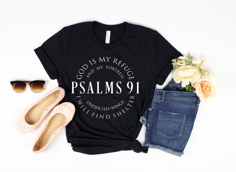 May include: Black t-shirt with white text that reads "God is my refuge and my fortress Psalms 91 Under his wings I will find shelter".