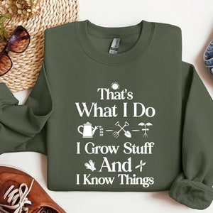 May include: A green sweatshirt with white text that reads "That's What I Do I Grow Stuff And I Know Things". The text is accompanied by gardening-related icons.