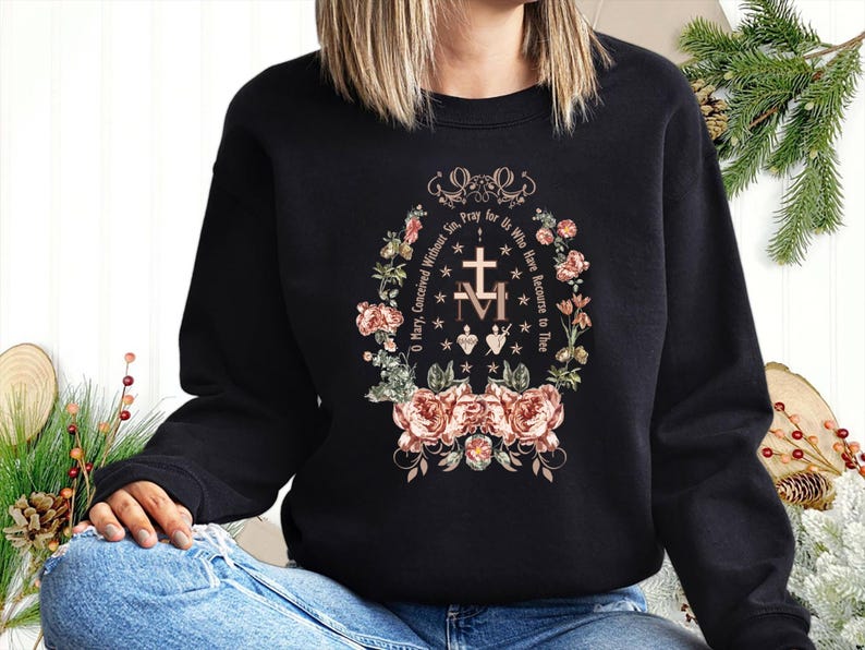 May include: Black sweatshirt with a floral design and the text "O Mary, Conceived Without Sin, Pray for Us Who Have Recourse to Thee" in a circular pattern.