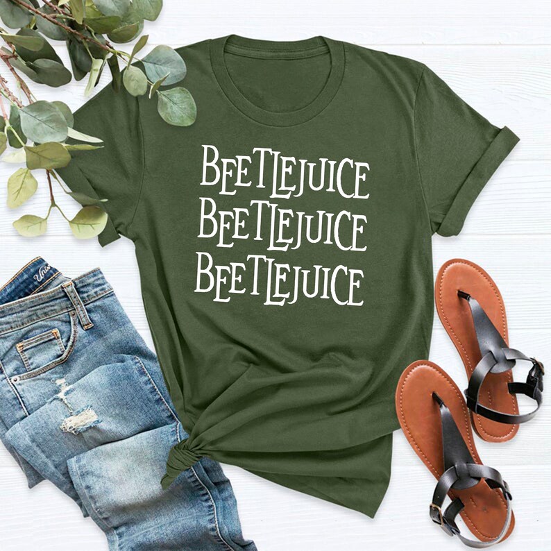 May include: A green t-shirt with the words "Beetlejuice" repeated three times in white text.
