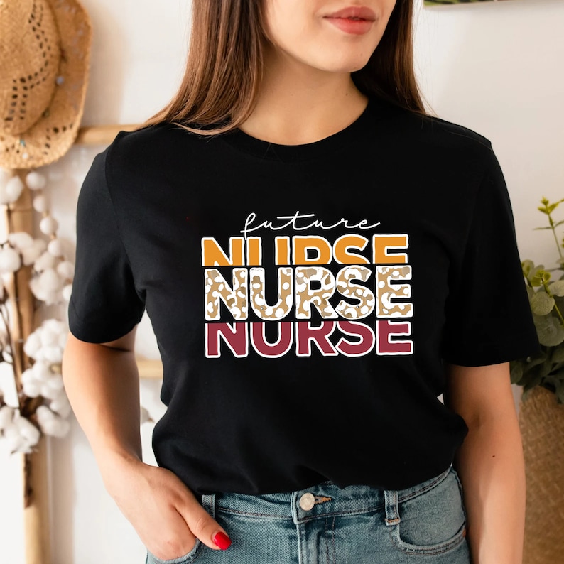 May include: Black t-shirt with the text "future nurse" in white and orange. The word "nurse" is repeated twice, with the second instance in a leopard print pattern.