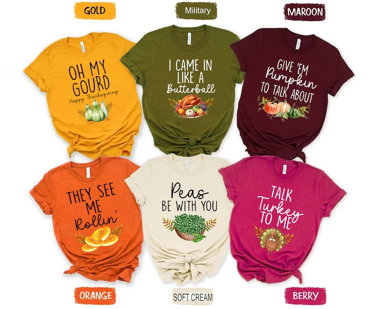Puede incluir: Seis camisetas de diferentes colores con texto y gr&aacute;ficos de tem&aacute;tica de Acci&oacute;n de Gracias. Las camisetas son de color dorado, verde militar, granate, naranja, crema y baya.