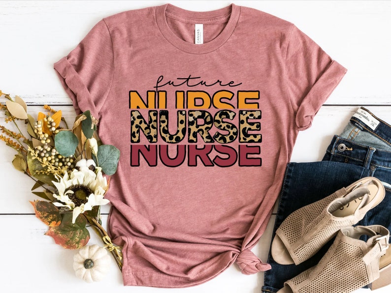 May include: A pink t-shirt with the text "future nurse" in orange, yellow, and red with a leopard print design.