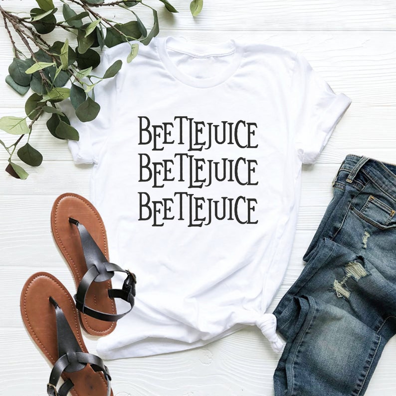 May include: White t-shirt with the text "BEETLEJUICE" repeated three times in black.