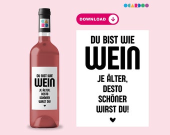 May include: A printable wine bottle label with the text "Du bist wie Wein Je älter, desto schöner wirst du!" in black text on a white background.