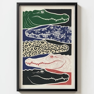 May include: Framed art print featuring five stylized alligator heads in various patterns and colors. The artwork includes a green alligator head, a blue floral pattern, a leopard print, a red and white design, and a black alligator head.