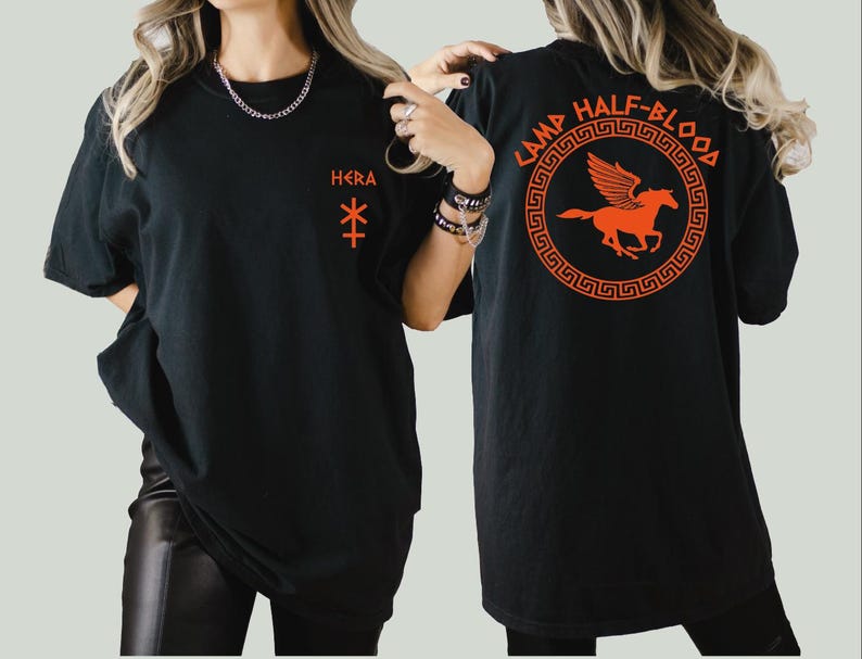 a woman wearing a black t - shirt with an orange horse on it