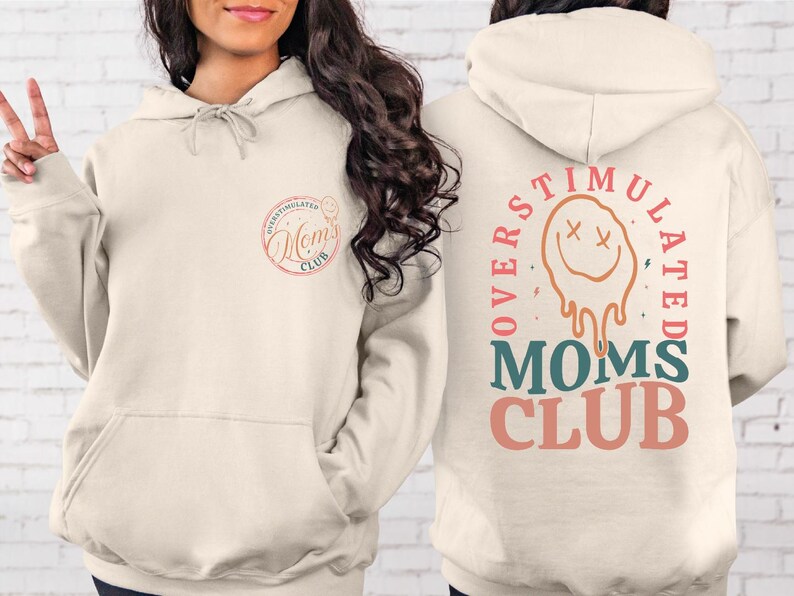 a woman wearing a hoodie with the words mother's club written on it