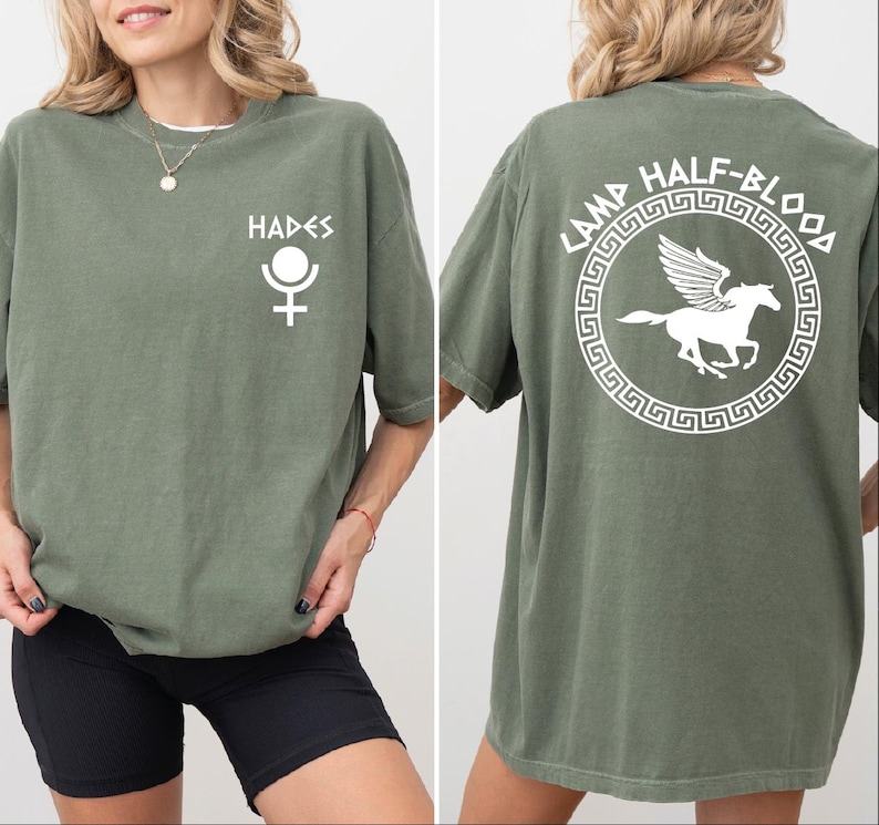 a woman wearing a green shirt with a white horse on it