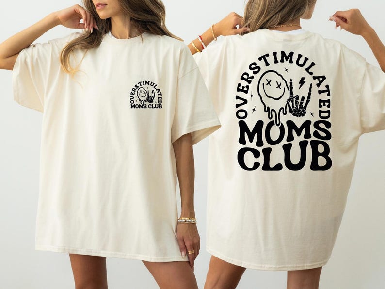 two women wearing white shirts with black letters on them