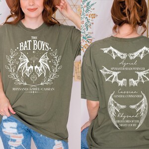 a woman wearing a bat box t - shirt