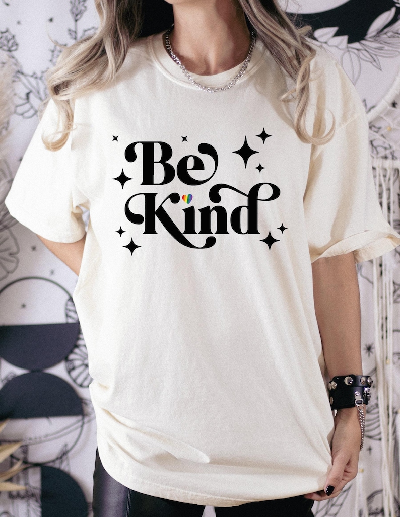 a woman wearing a t - shirt that says be kind