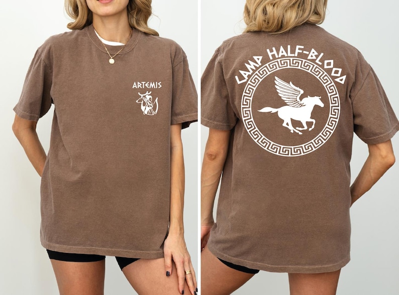 a woman wearing a brown shirt with a white horse on it