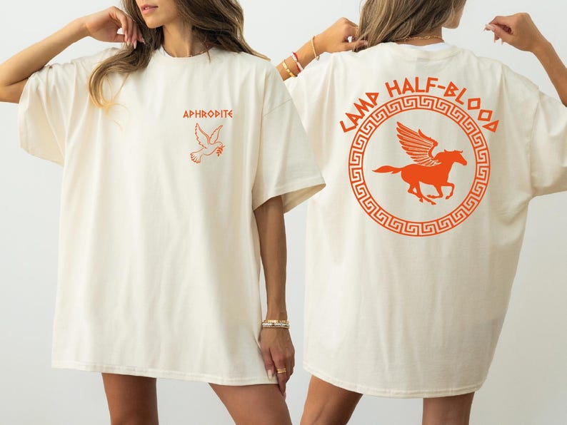 two women in white t - shirts with orange logos