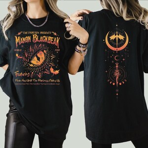 a woman wearing a black shirt with a dragon on it