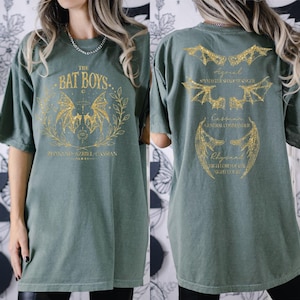 a woman wearing a green bat boy shirt