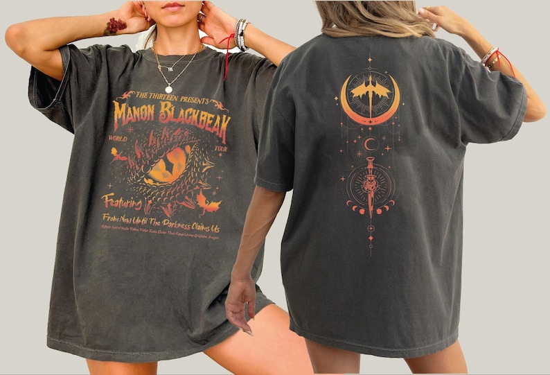 a woman wearing a black shirt with an orange design on it