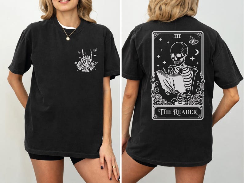 a woman wearing a black t-shirt with a graphic design on the back. The design features a skeleton holding a book, with the text "The Reader" below the skeleton.