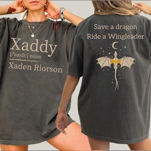 May include: Dark gray oversized t-shirt with the word "Xaddy" and the definition on the front. The back of the shirt features a dragon graphic with the text "Save a dragon Ride a Wingleader".