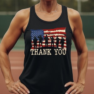 a woman wearing a black tank top with an american flag on it