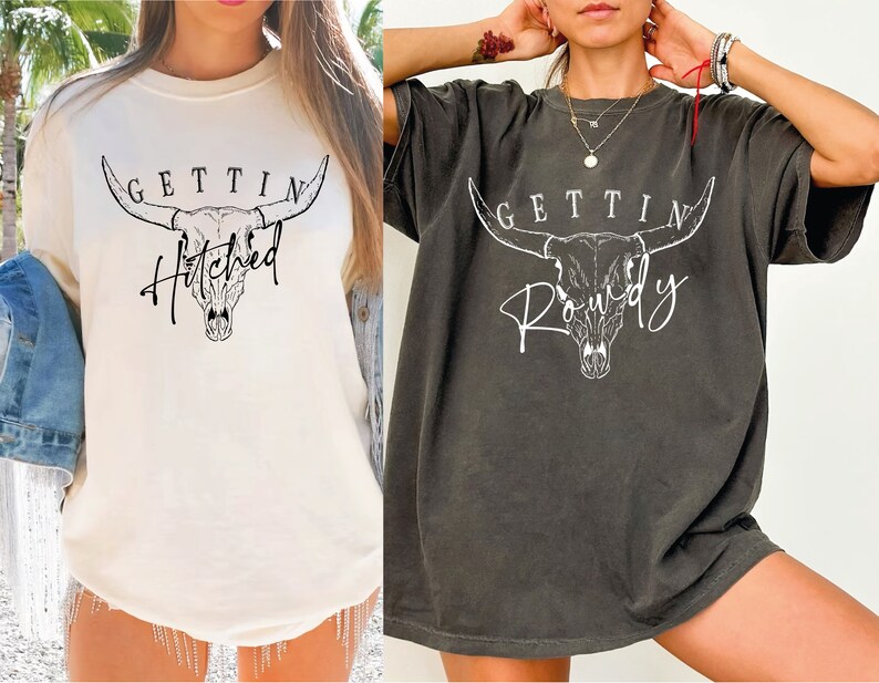 two women wearing t - shirts with a bull head on them