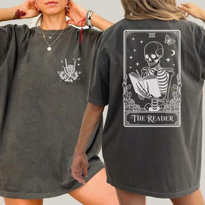 two different views of a person wearing a gray t-shirt with a graphic design on the back.