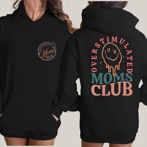 a woman wearing a black hoodie with a lion on it