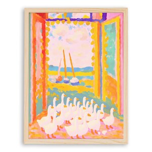 May include: A framed art print featuring a colorful impressionistic painting. The artwork depicts a flock of white geese in the foreground, with a view of sailboats on the water through an open window. The frame is a light wood color.