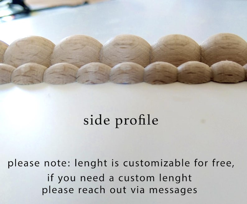 Side profile of two rows of wooden beads of different sizes