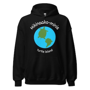 May include: Black hooded sweatshirt with a graphic of a turtle on a blue globe. The text "Mikinaako-minis" and "Turtle Island" are printed in white on the sweatshirt.