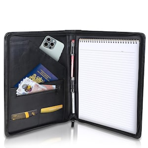 May include: Black leather zipped portfolio with a notepad, pen, phone, credit cards and cash. The portfolio has multiple pockets and slots for organisation.
