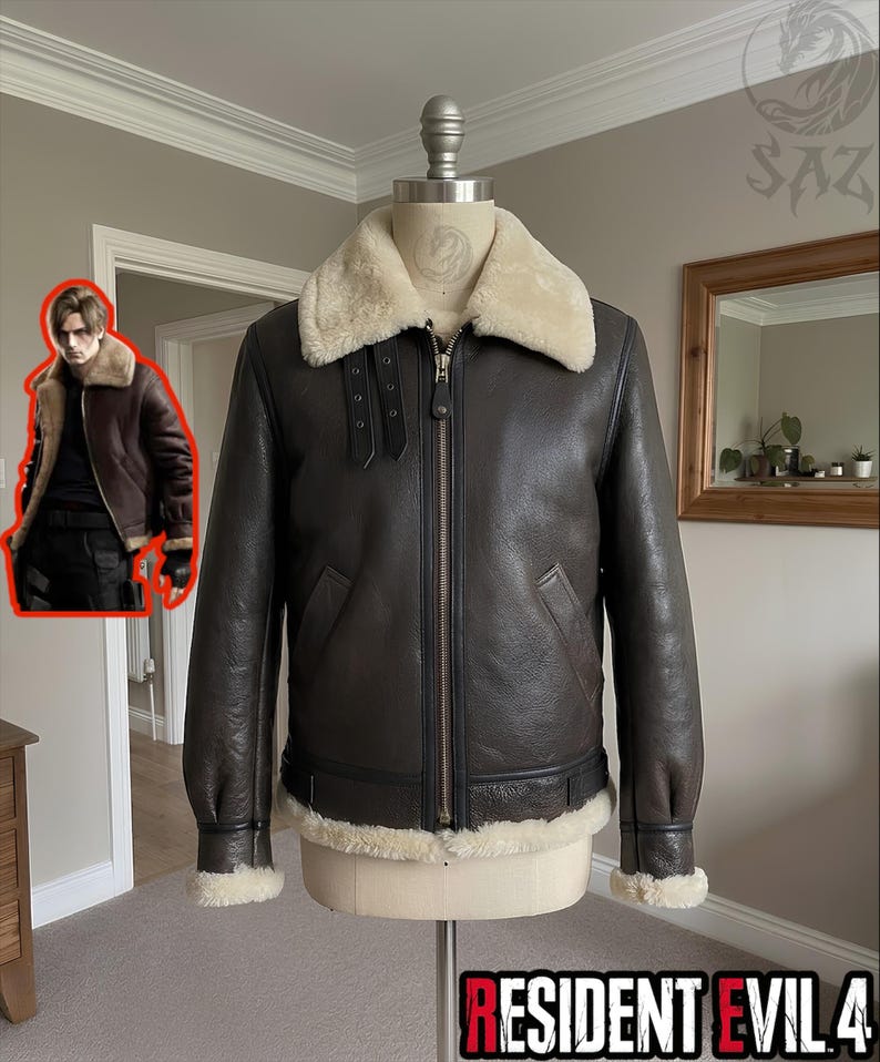 May include: A dark brown leather bomber jacket featuring a cream-colored shearling collar, cuffs, and hem. The jacket includes a central metal zipper, two black buckled throat latch straps on the collar, and long sleeves on a mannequin torso.