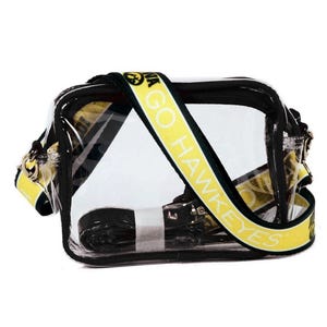 May include: Clear plastic crossbody bag with a black strap and a yellow strap with the text "GO HAWKEYES" printed on it.