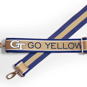 May include: A navy blue and gold striped adjustable strap with the text "GT GO YELLOW JACKETS" printed on it.