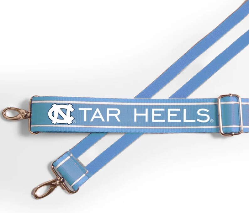 May include: A light blue and white striped adjustable strap with the text "TAR HEELS" and a white "NC" logo.